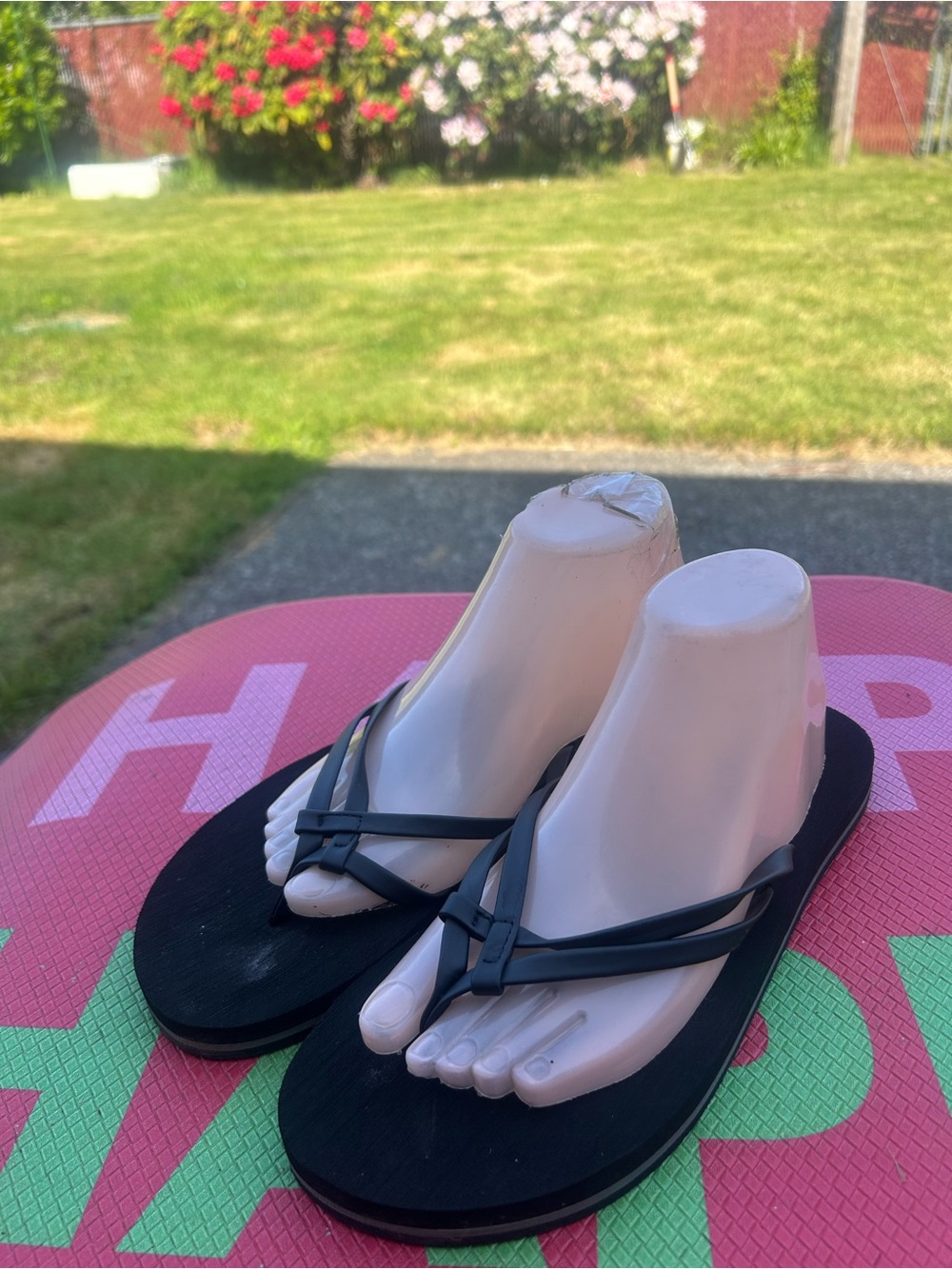 ZeroXposur flip flops featuring a knotted strap design and branded footbeds